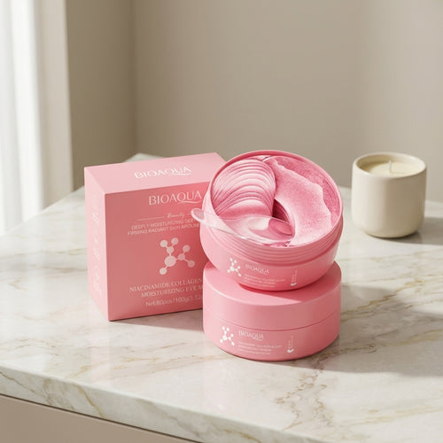 Open jar of pink hydrogel eye patches stacked on a second jar beside its box, on a marble counter next to a candle
