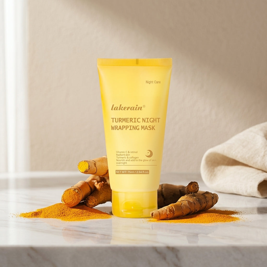 Yellow turmeric night wrapping mask tube standing on a bed of turmeric powder with fresh turmeric root beside it