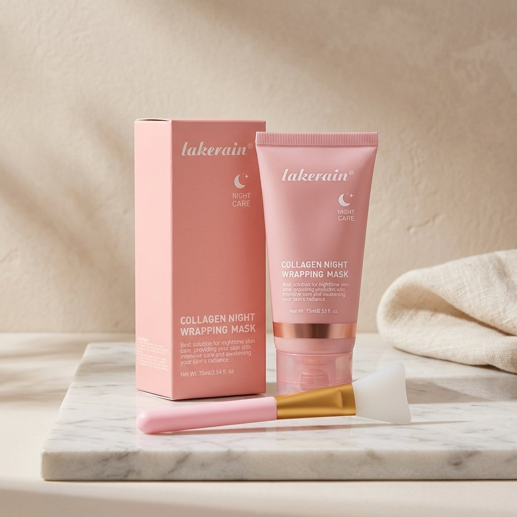 Pink collagen night wrapping mask tube and its box on a marble slab, with the silicone applicator brush lying in front