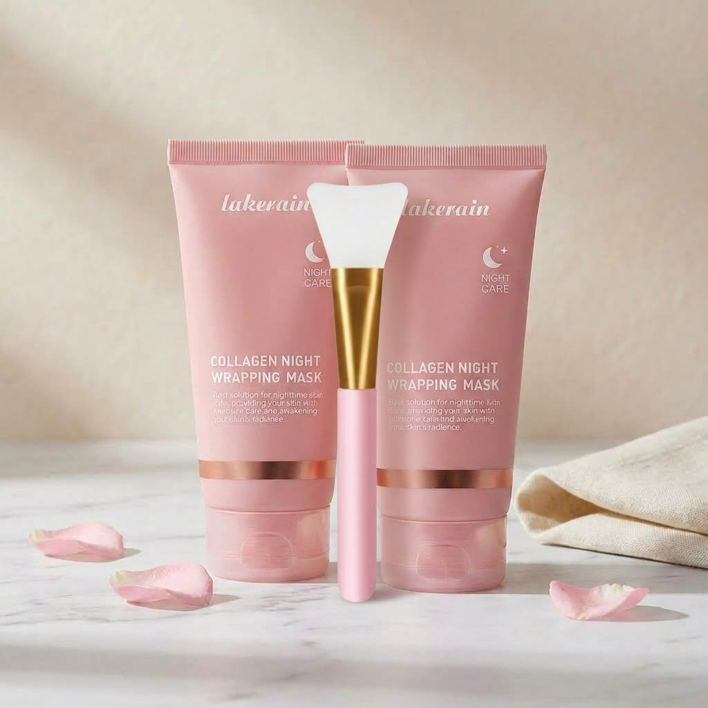 Collagen duo with the brush: two pink night mask tubes and the silicone applicator on marble with rose petals