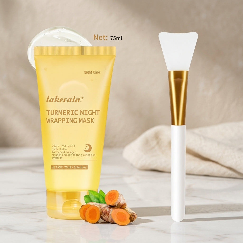 Yellow turmeric night wrapping mask tube beside the silicone applicator brush, with fresh turmeric root at its base